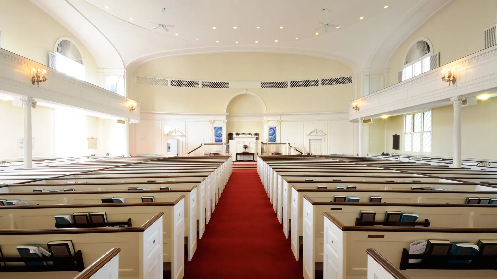 Clean, sunlit sanctuary with polished floors and neatly arranged seating in a Northern Virginia church.